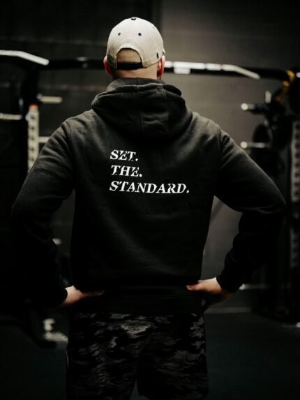 Black hoodie from The Trace featuring Set the Standard design symbolizing the pursuit of the highest performance