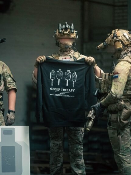 Black hoodie from The Trace featuring Group Therapy design with four targets marked by tight bullet hole groupings