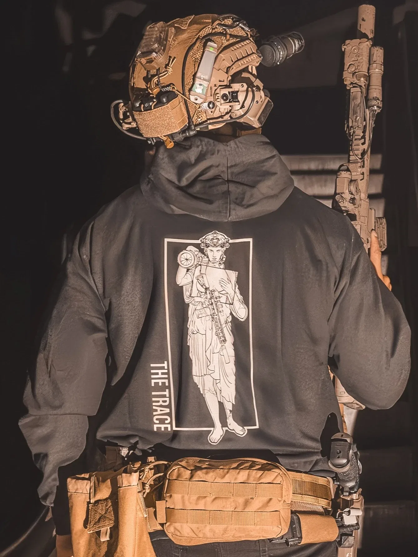 black hoodie featuring a girl carrying an anti tank weapon.