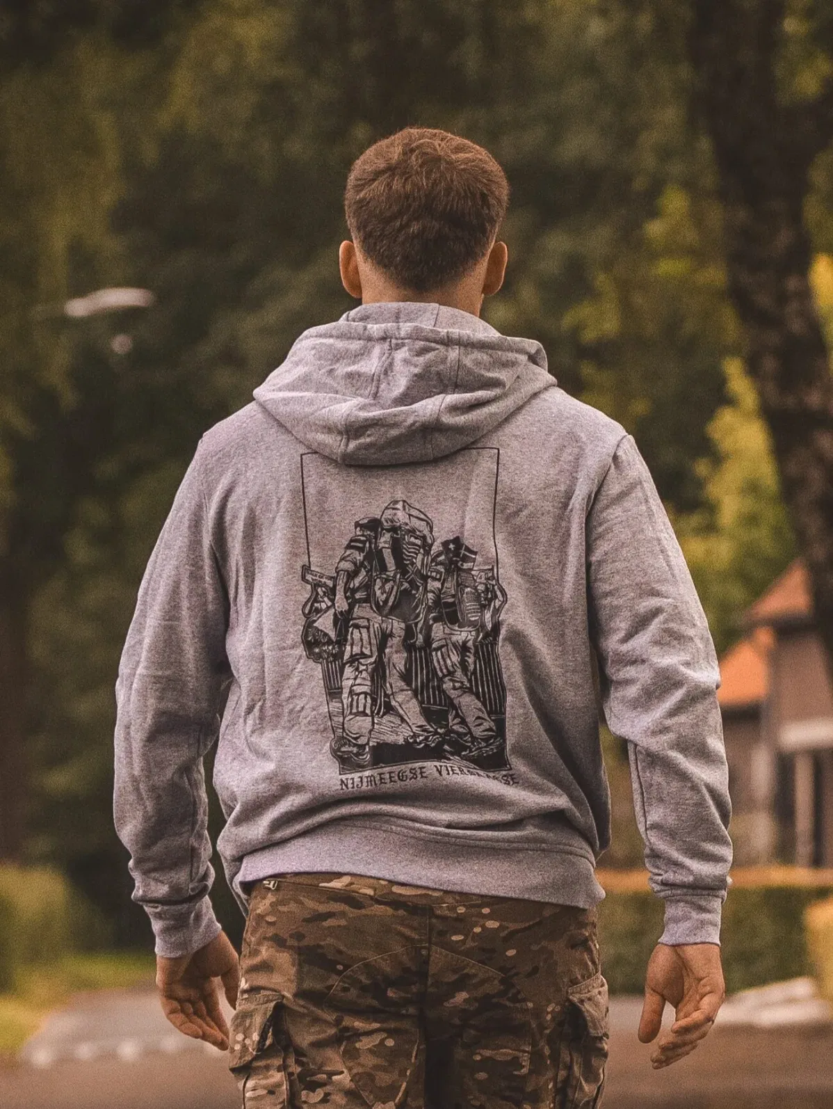 heather grey hoodie from The Trace featuring design of two soldiers marching in the Nijmegen Four Days Marches
