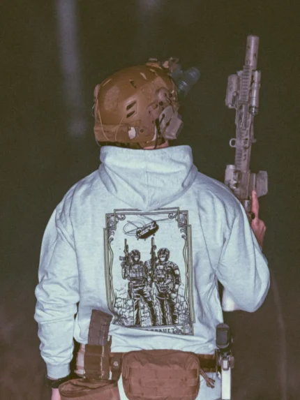 the trace apparel collection featuring 2 air assault operators standing in front of a chinook