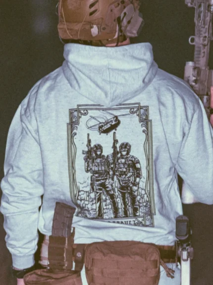 the trace apparel collection featuring 2 air assault operators standing in front of a chinook