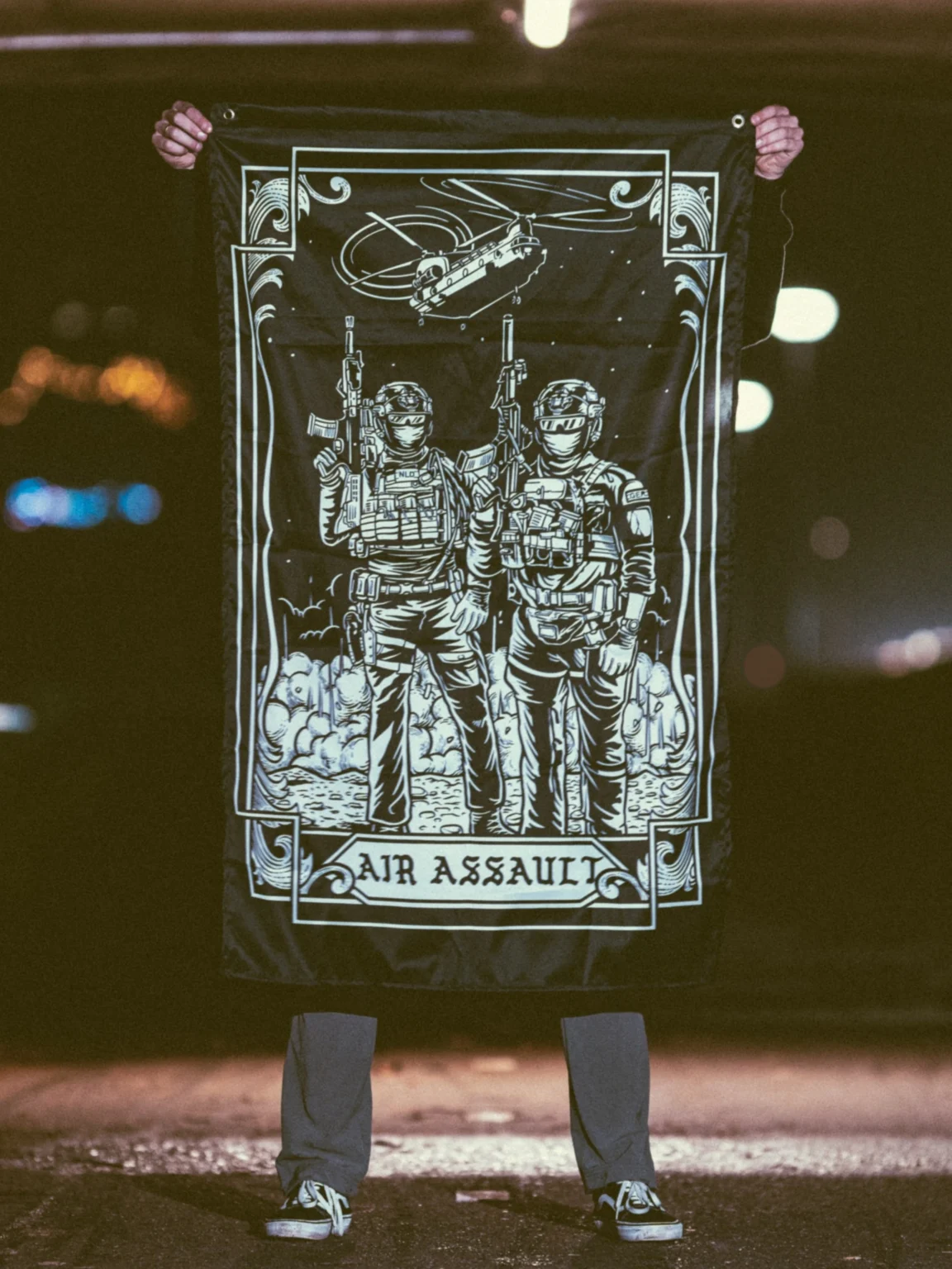 the trace apparel collection featuring 2 air assault operators standing in front of a chinook