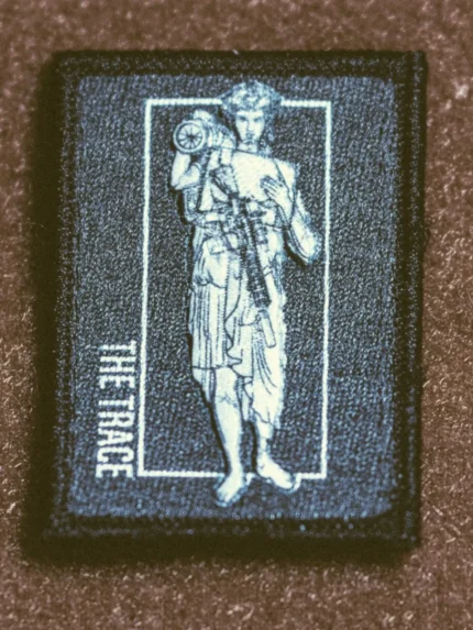 the trace apparel collection patch featuring a woman holding a anti tank weapon