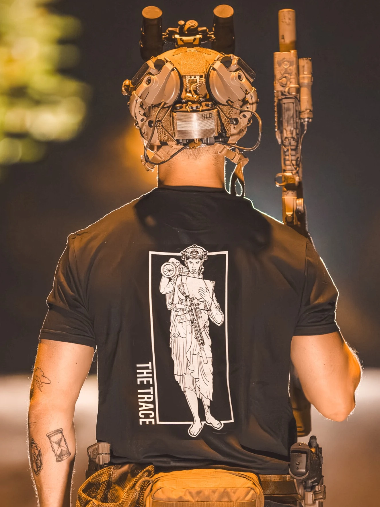 black shirt featuring a girl carrying an anti tank weapon.