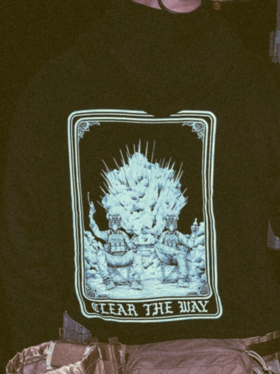 the trace apparel collection with 2 guys sitting in front of a explosing because they are part of the eod