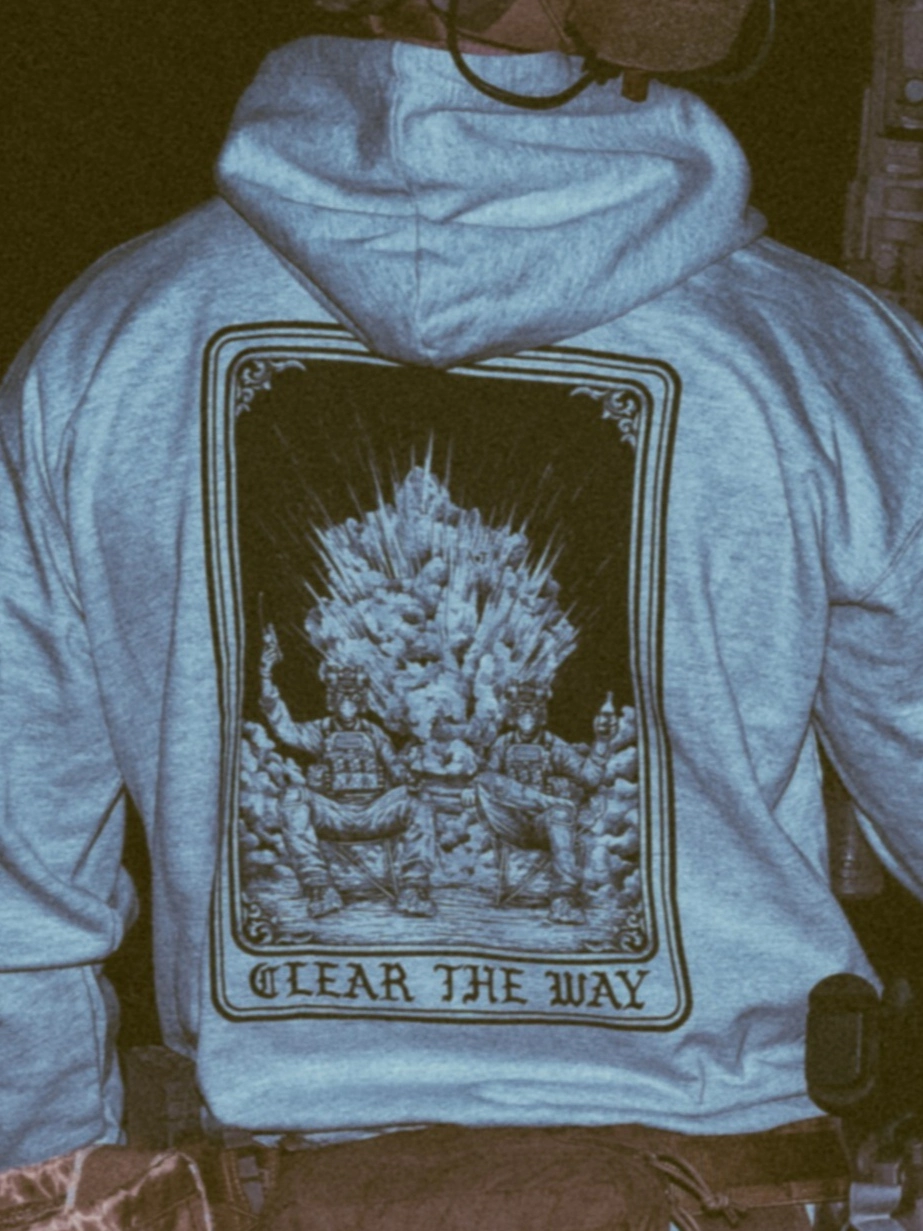 the trace apparel collection with 2 guys sitting in front of a explosing because they are part of the eod