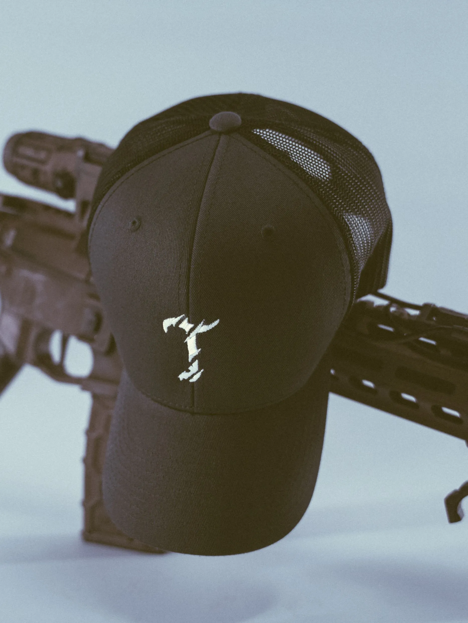 The Trace military trucker cap with embroidered logo and mesh back