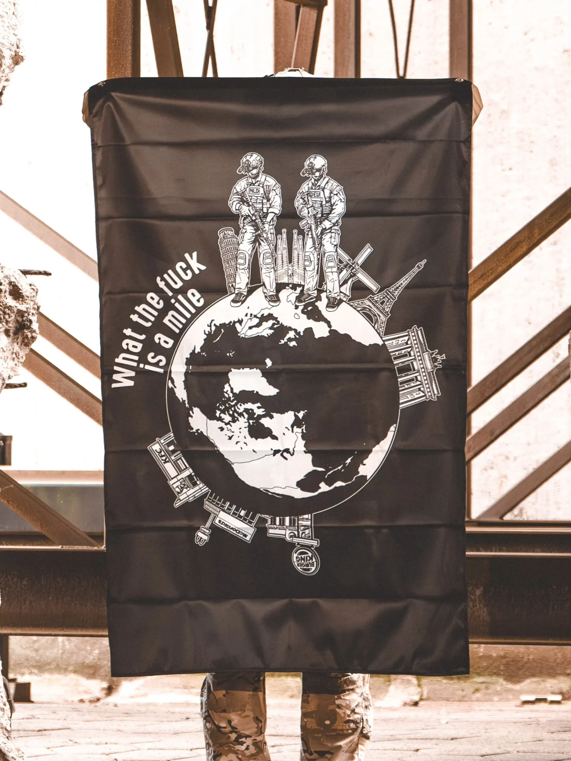 the trace apparel collection featuring 2 operators standing on europe and watching america saying wtf is a mile