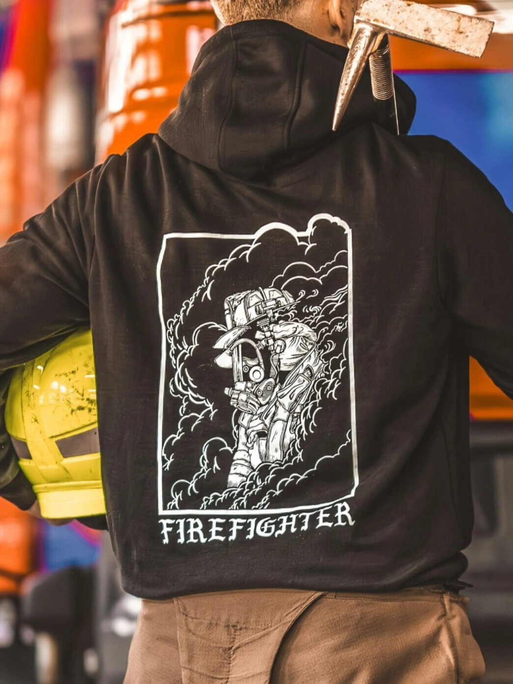 the trace hoodie featuring a firefighter standing in front of a firetruck