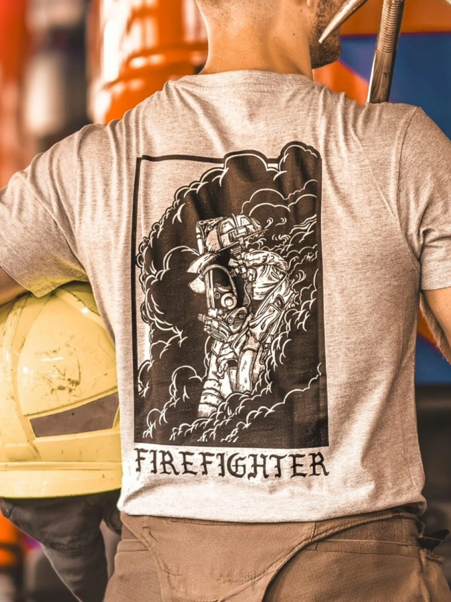 the trace shirt featuring a firefighter standing in front of a firetruck