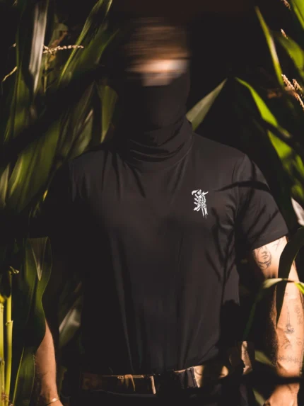 Halloween Skeleton Logo T-shirt in black by The Trace, chest print of a skeleton hand holding the T logo