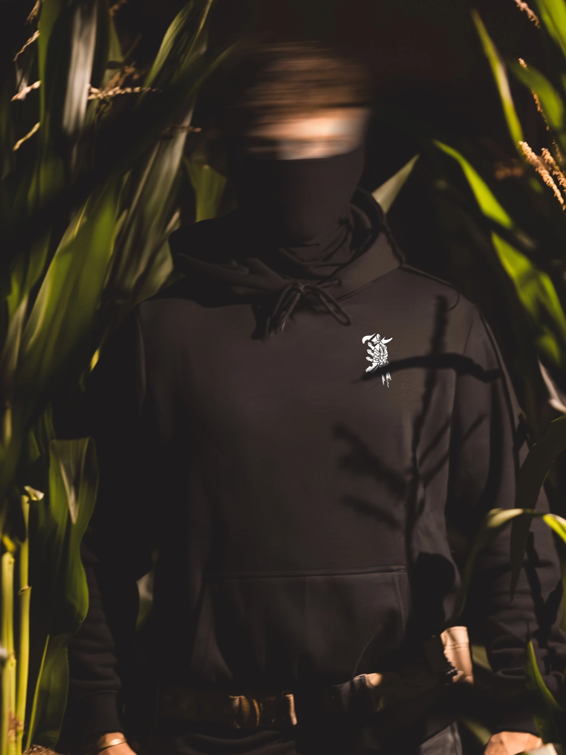 Halloween Skeleton Logo hoodie in black by The Trace, chest print of a skeleton hand holding the T logo